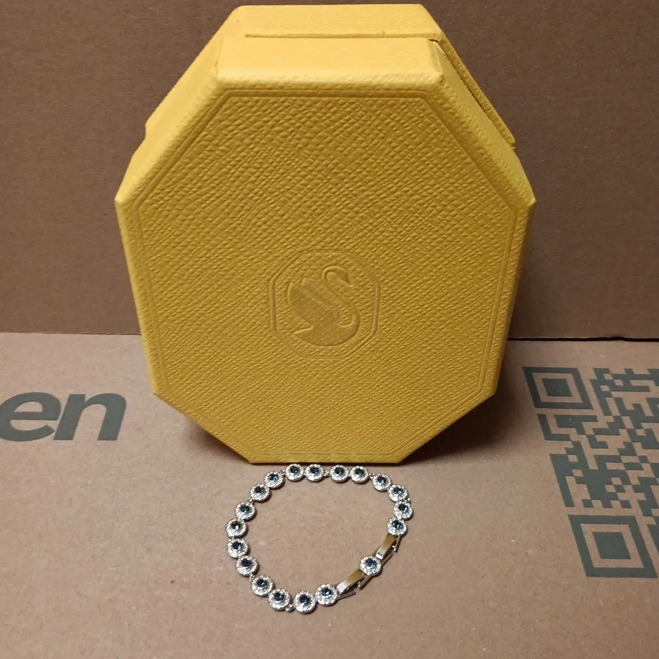 BOXED SWAROVSKI SILVER-TONE BRACELET WITH BLUE STONES IN ROUND BEZEL LINKS