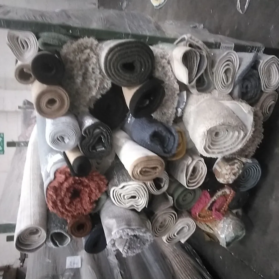STILLAGE OF APPROXIMATELY 40 DESIGNER RUGS