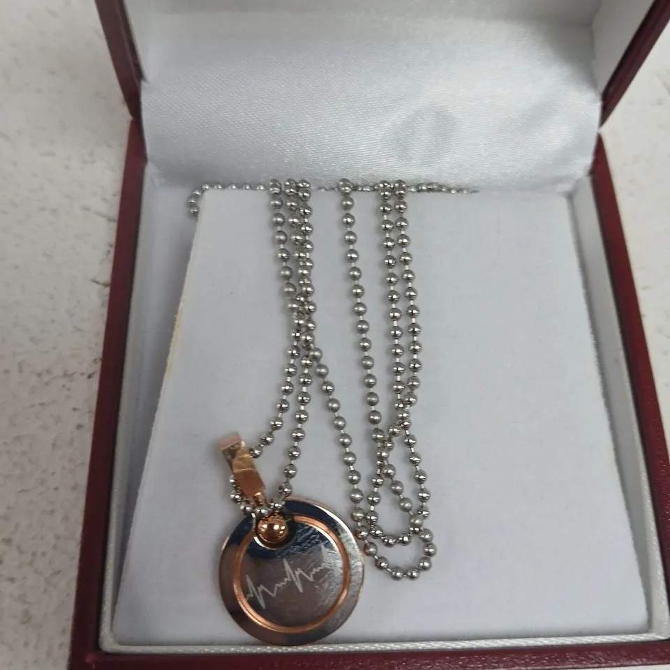 ROSE GOLD-TONE CIRCULAR PENDANT NECKLACE WITH ENAMEL HEARTBEAT MOTIF