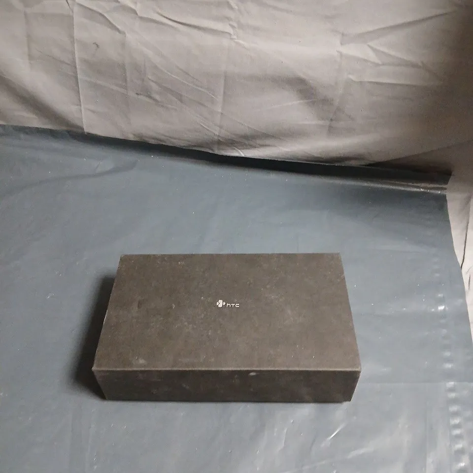 HTC SMARTPHONE IN BOXED PACKAGING – FOAM INSERTS AND HEADSET-LIKE ACCESSORIES 