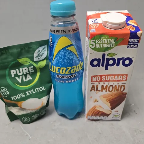 APPROXIMATELY 6 ASSORTED FOOD & DRINK ITEMS TO INCLUDE - ALPRO ALMOND , LUCOZADE BLUE BURST , PUREVIA 100% XYLITOL ETC