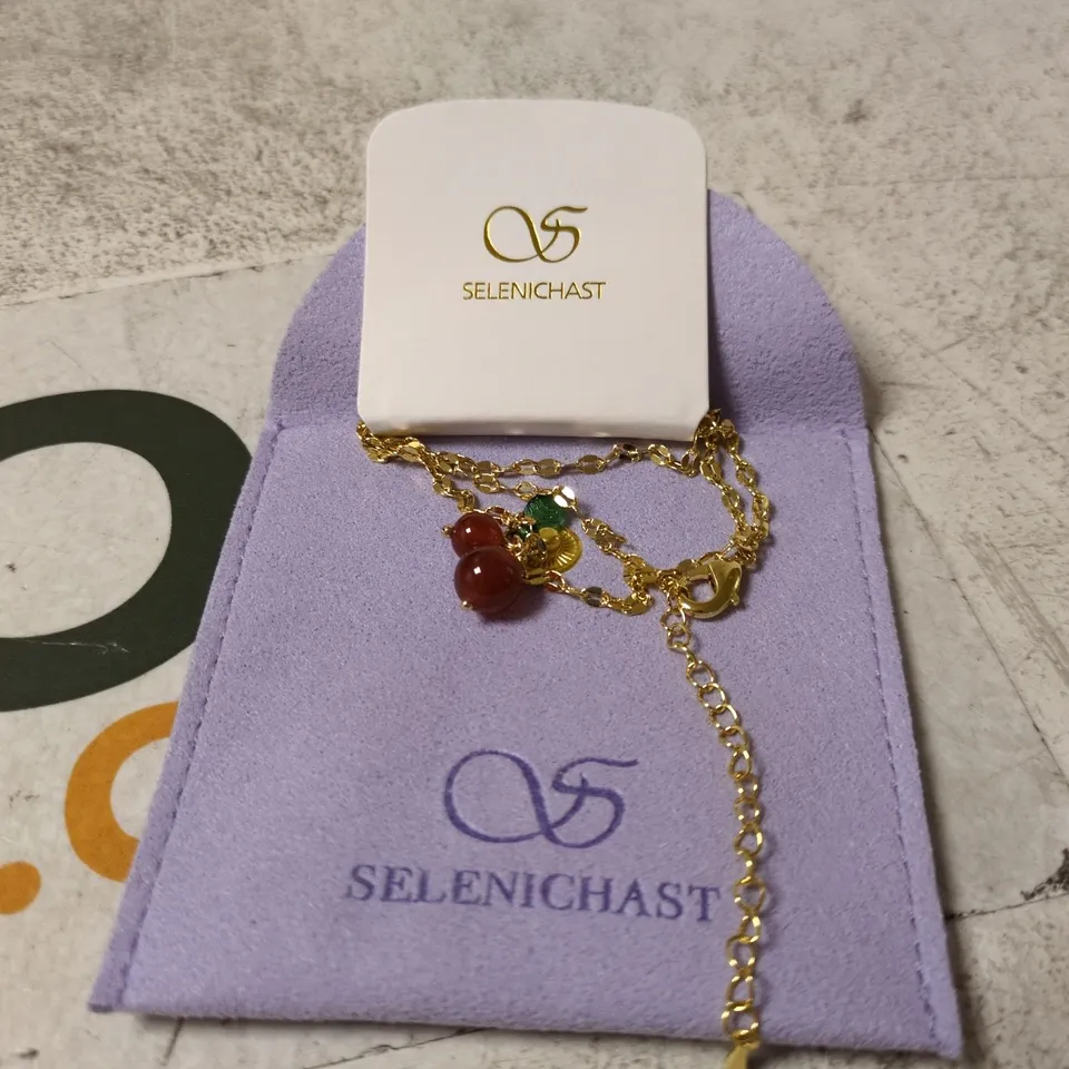 SELENICHAST GOLD-TONE BRACELET WITH RED BEAD CHARMS – BOXED