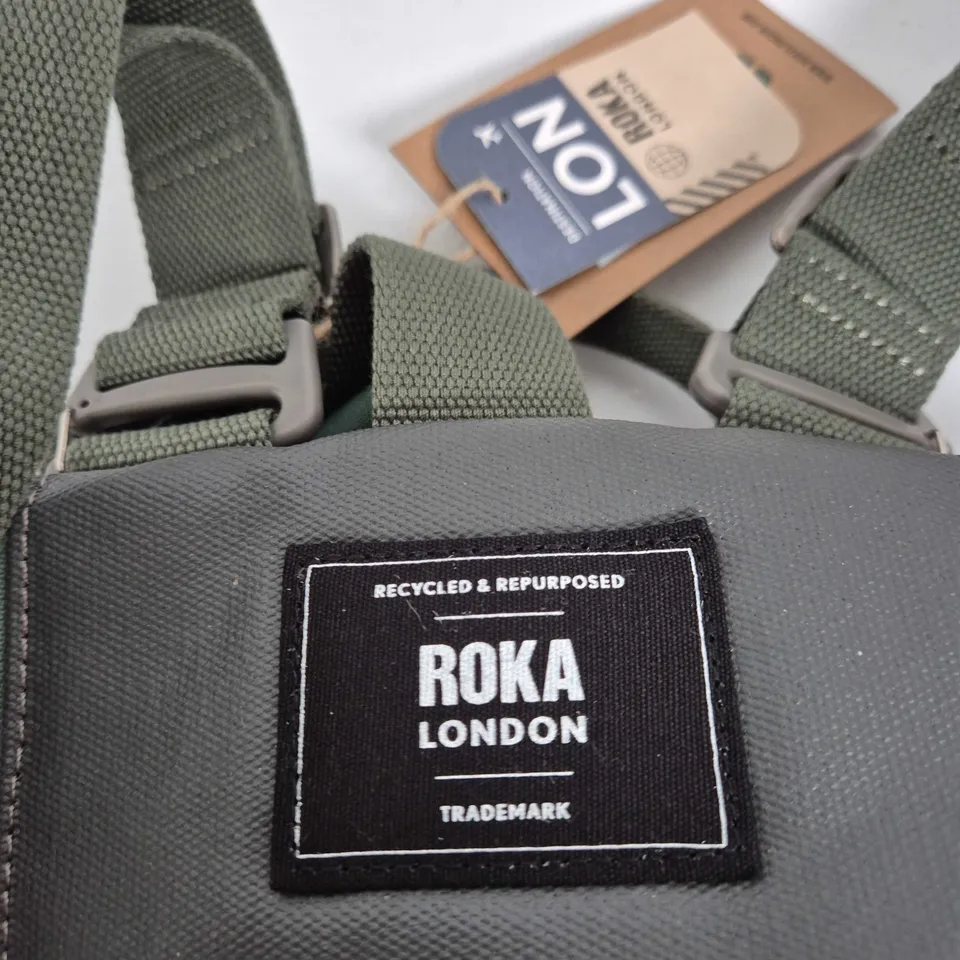 ROKA LONDON CAMOUFLAGE ROUND BAG WITH RED ZIP AND WEBBING STRAPS