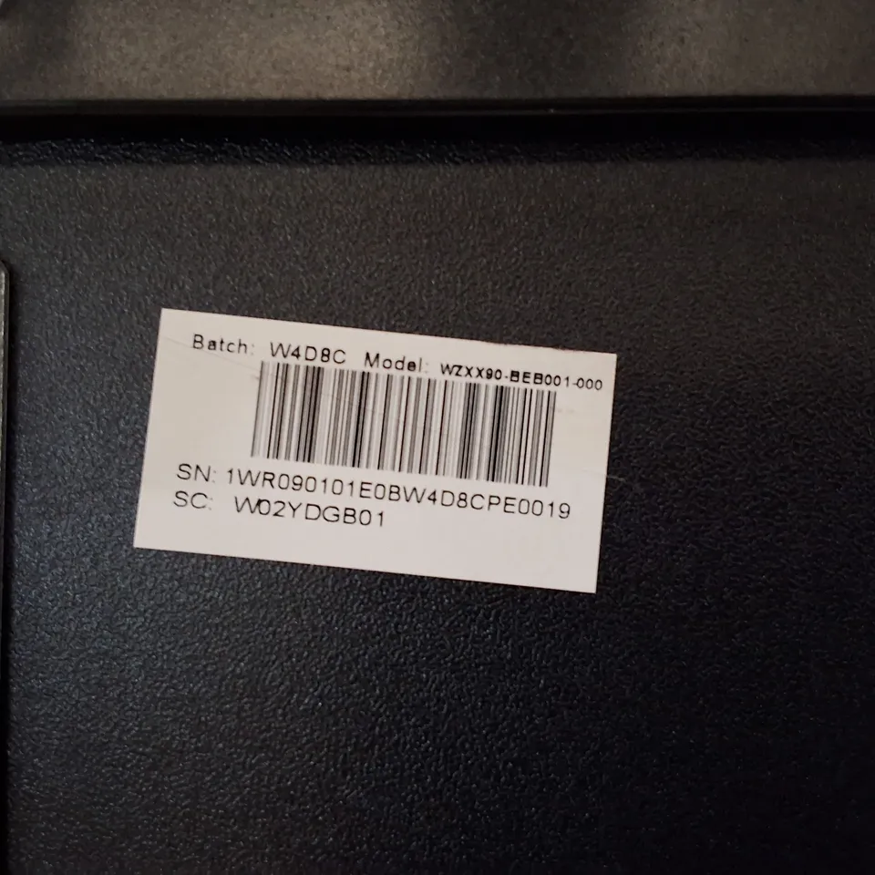 Black plastic chassis/slot component (Model WZXX90-BE B001-000) – likely peripheral