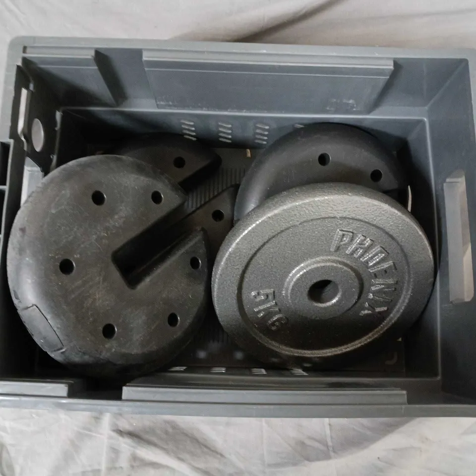 Weight plates in plastic crate – gym weights