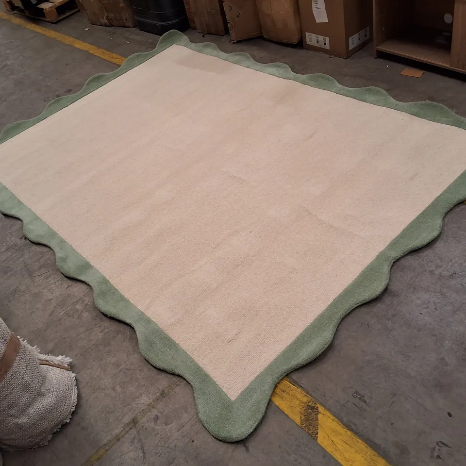 BEIGE RUG WITH GREEN SCALLOPED BORDER APPROXIMATELY 200×290CM
