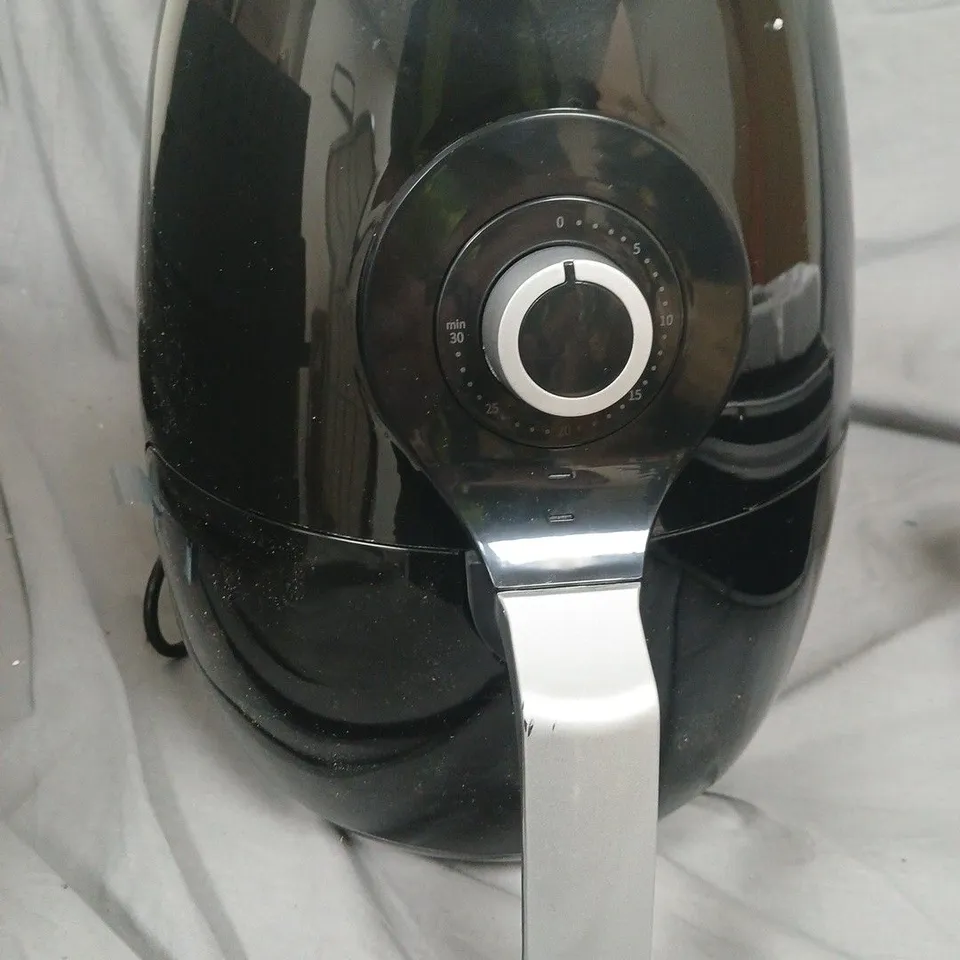 Black air fryer with chrome handle and circular timer dial 