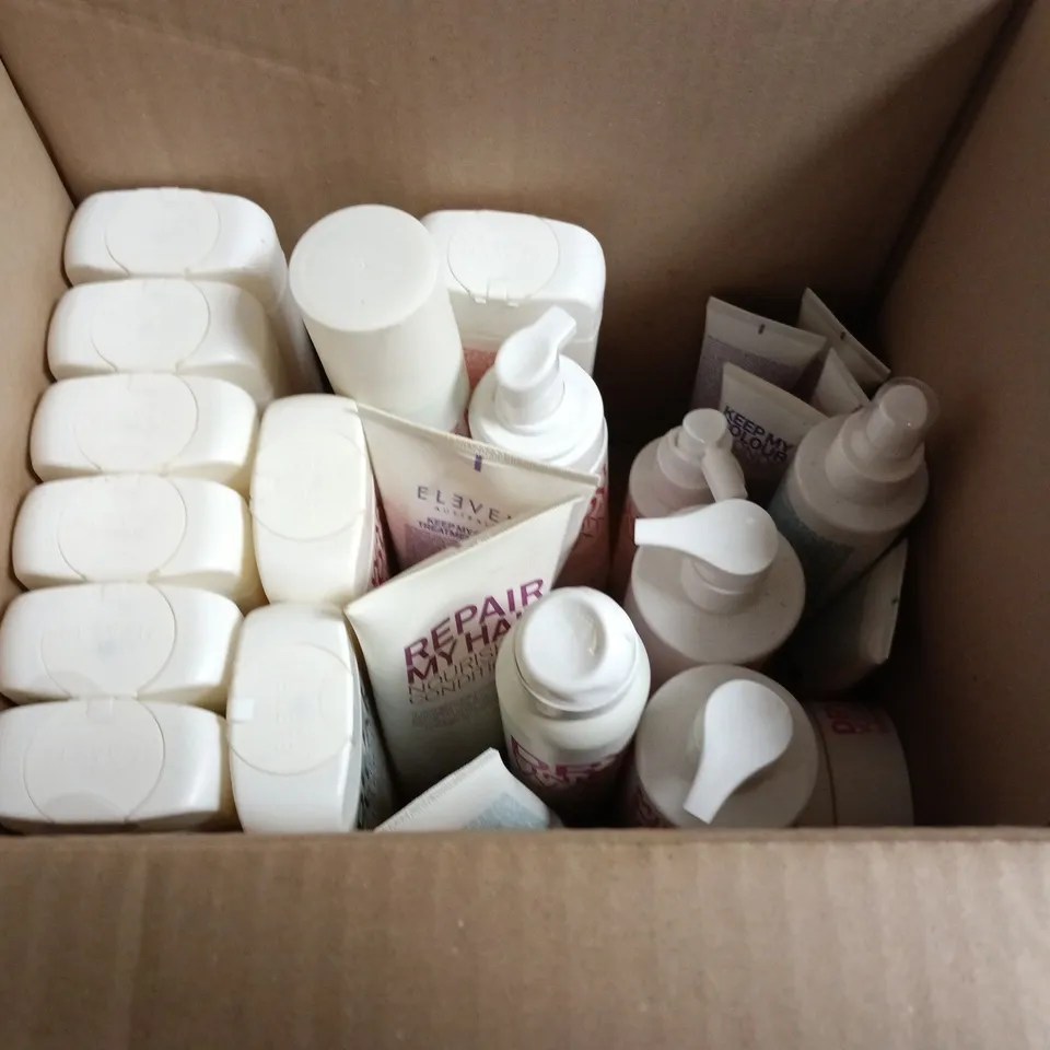 BOX OF APPROXIMATELY 25 ELEVEN HAIRCARE PRODUCTS TO INCLUDE 3 MINUTE REPAIR TREATMENT, GENTLE CLEAN BALANCING SHAMPOO AND I WANT BODY TEXTURE SPRAY