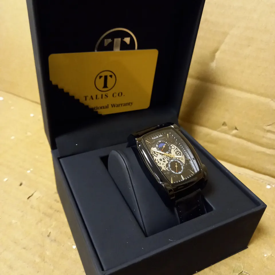 MENS TALIS CO WATCH, CHRONOGRAPH MOVEMENT. BLACK LEATHER STRAP, SLEEK BLACK/SILVER SKELETON DIAL