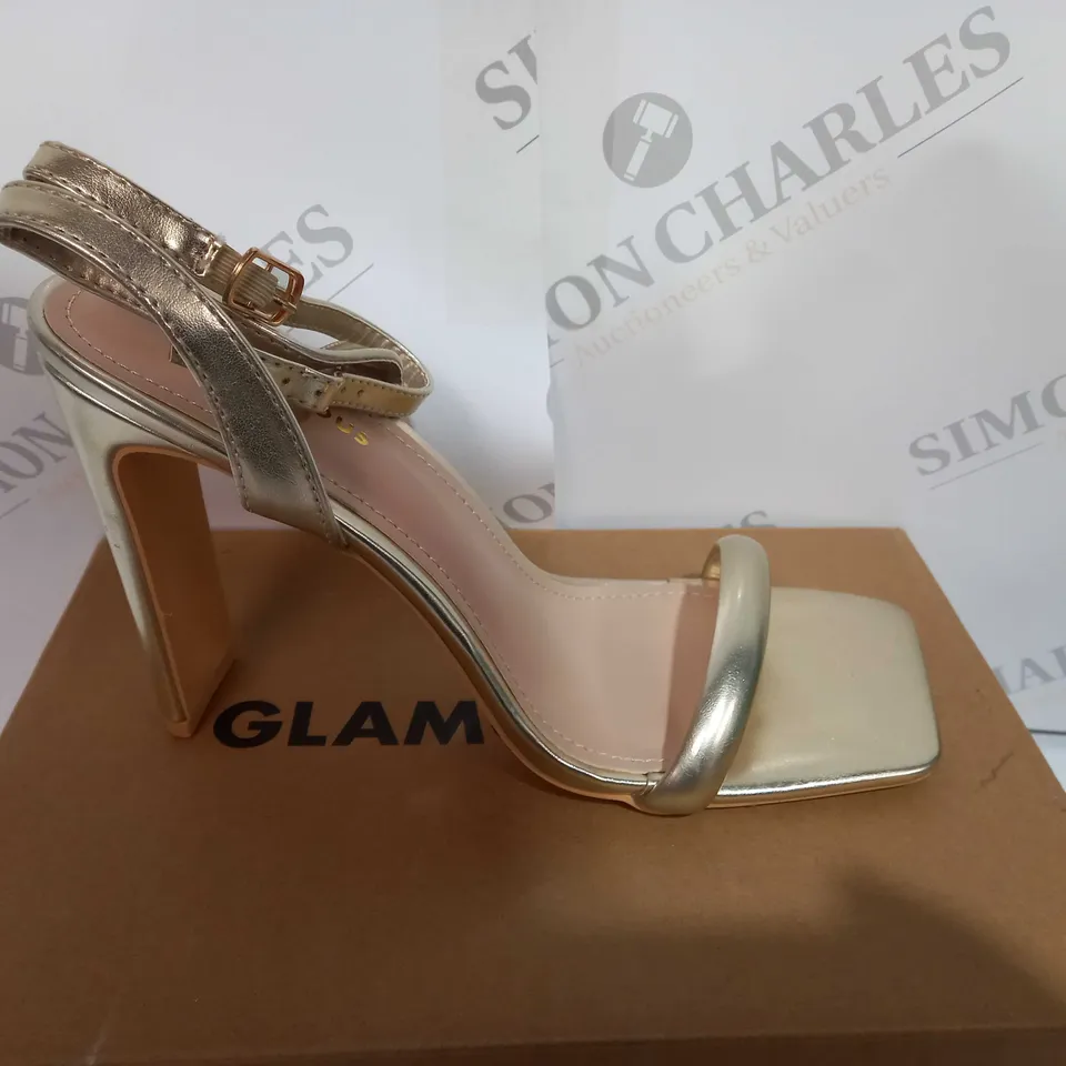 BOXED PAIR OF LADIS GLAMOROUS HEELS IN GOLD SIZE UK7 