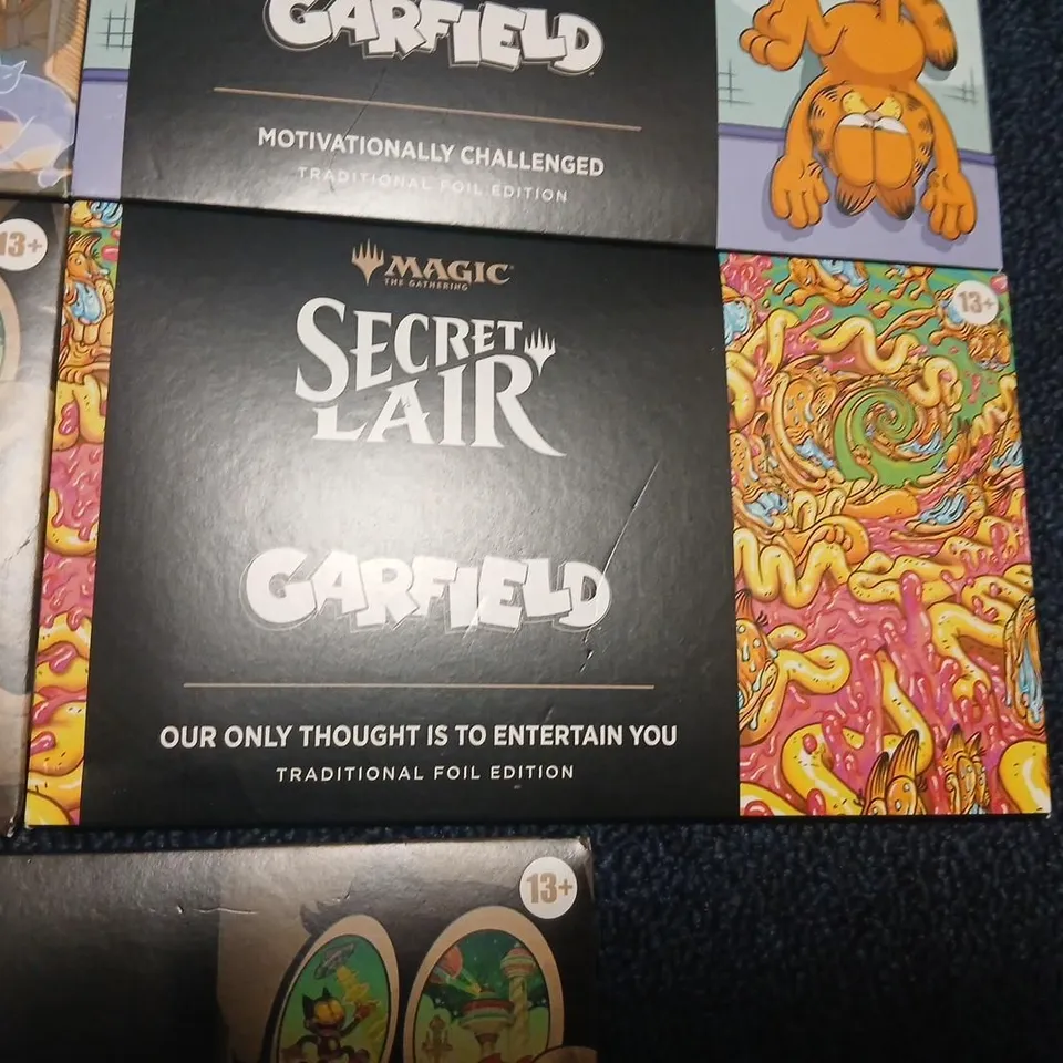 SIX ASSORTED MAGIC: THE GATHERING SECRET LAIR BOOSTERS TO INCLUDE; GARFIELD & FELIX THE CAT EACH PACK CONTAINS 5 CARDS