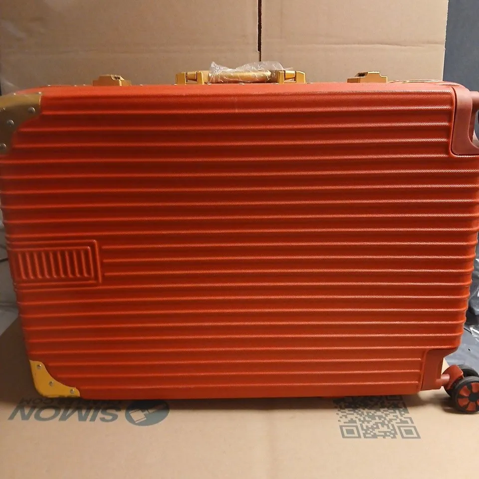 RED HARD-SHELL SUITCASE WITH GOLD-TONE CORNERS; LINING WITH HEART PATTERN. WITH SIDE CARRY HANDLE OPTION