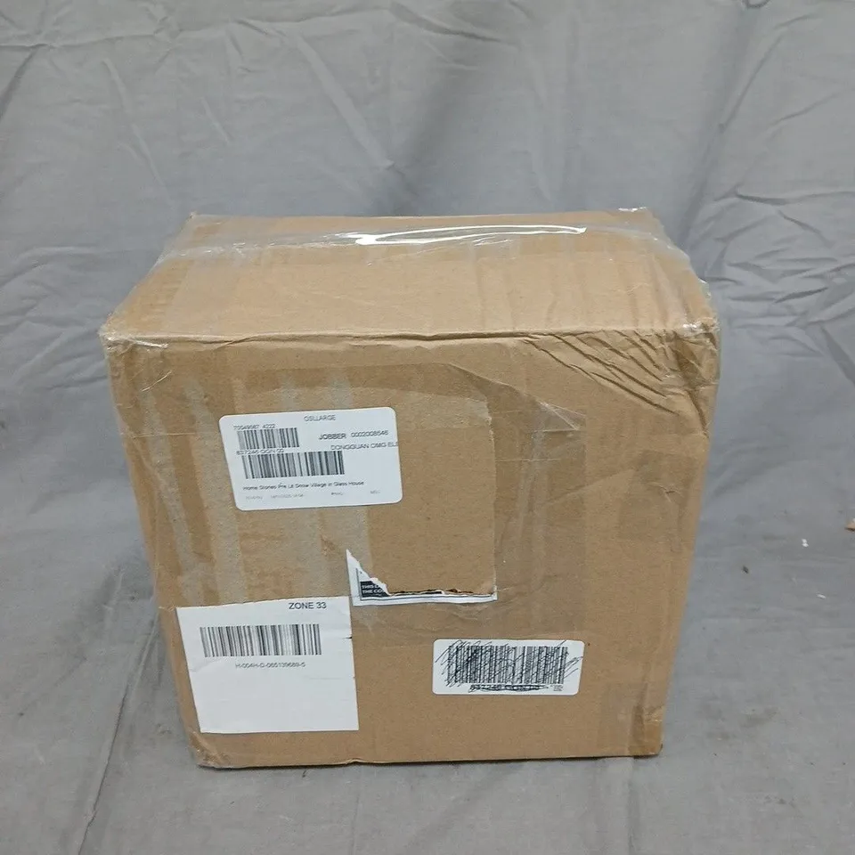 HOME STORIES PRE LIT SNOW VILLAGE IN GLASS HOUSE - GOLD COLOUR