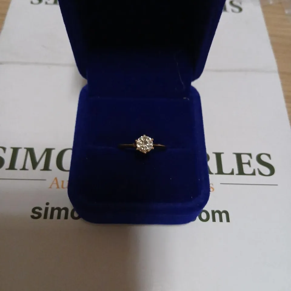 GOLD-TONE RING WITH CENTRAL CLEAR GEMSTONE