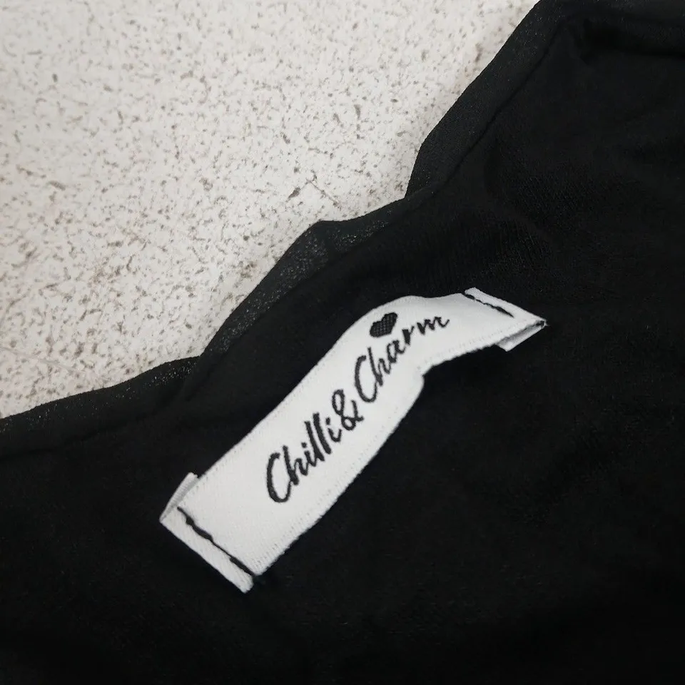 CHILL & CHARM BLACK KNIT TOP WITH PLEATED FRONT PANEL