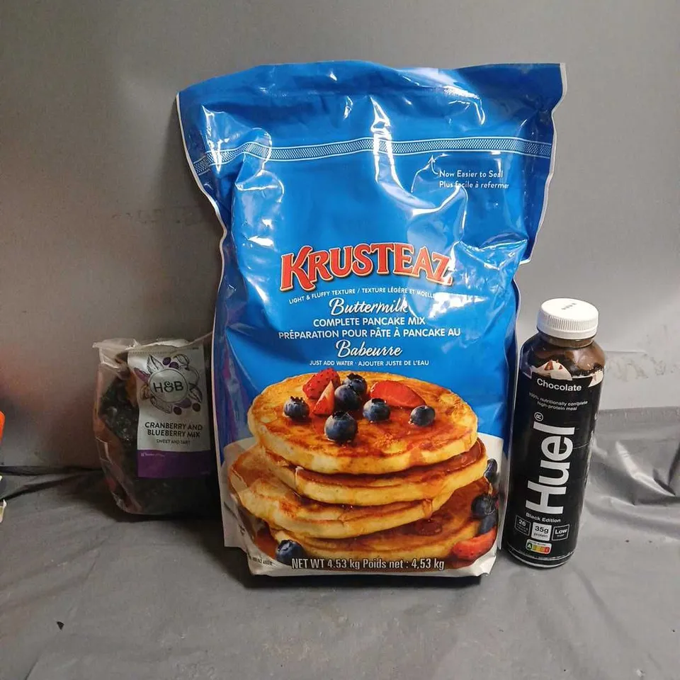 TOTE OF APPROX 3 ASSORTED FOOD ITEMS TO INCLUDE - HUEL CHOCOLATE , KRUSTEA BUTTERMILK PAMCAKE MIX , CRANBERRY & BLUEBERRY MIX 