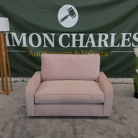 THE DUNSMORE LOVE SEAT SOFA BED UPHOLSTERED IN PETAL PINK FABRIC