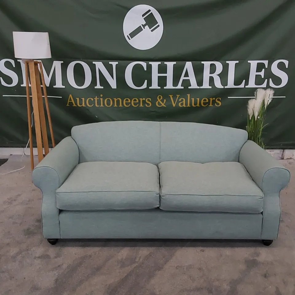 THE CHILMARK 3-SEATER SOFA UPHOLSTERED IN AQUA FABRIC