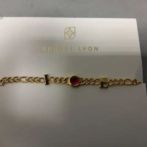 BOXED ABBOTT LYON CUSTOM INITIAL BRACELET IN GOLD W. RED JEWEL EFFECT