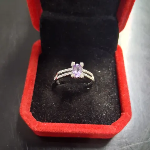 18CT WHITE GOLD RING SET WITH AN OVAL CUT AMETHYST AND NATURAL DIAMONDS