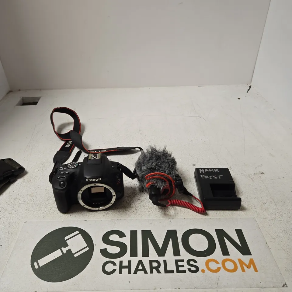 CANON DSLR CAMERA BODY (NO LENS) WITH EXTERNAL MICROPHONE, WINDSCREEN & CHARGER – INCLUDES CAMOUFLAGE BAG