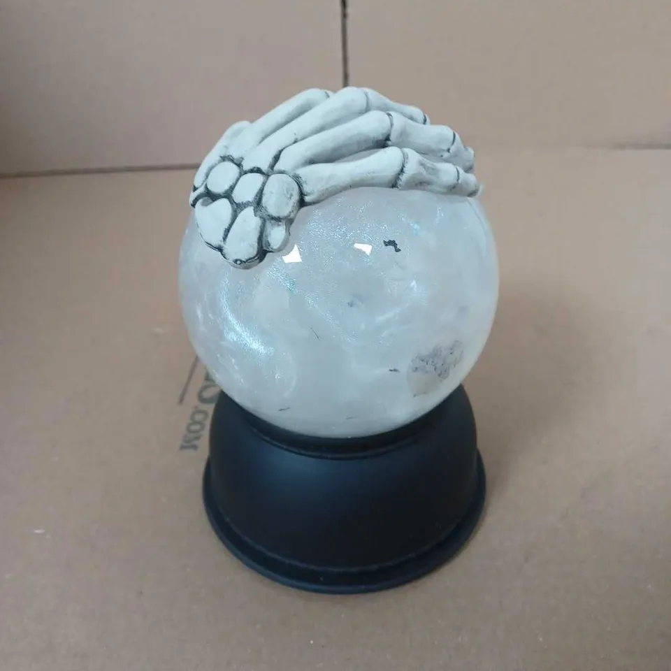 FESTIVE SKELETON HAND SNOW GLOBE 