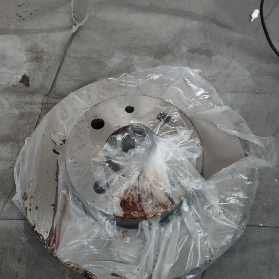 Vehicle brake rotor disc – rusted with central hub and bolt holes 