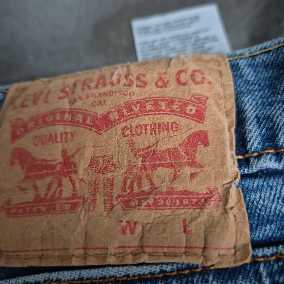 LEVI'S JEANS – BLUE DENIM WITH RED BACK PATCH SIZE UNSPECIFIED .