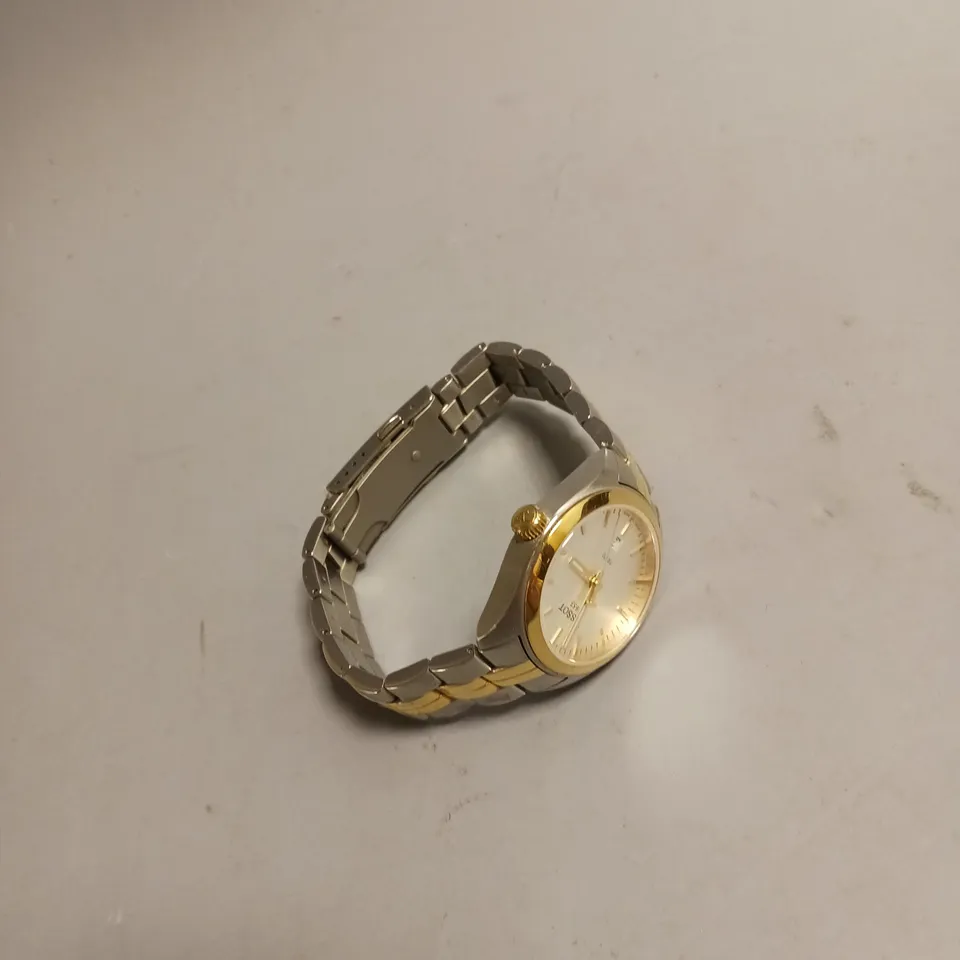 TISSOT WATCH IN GOLD AND SILVER INCLUDES BOOK THE STORY OF A WATCH COMPANY BY ESTELLER FALLET