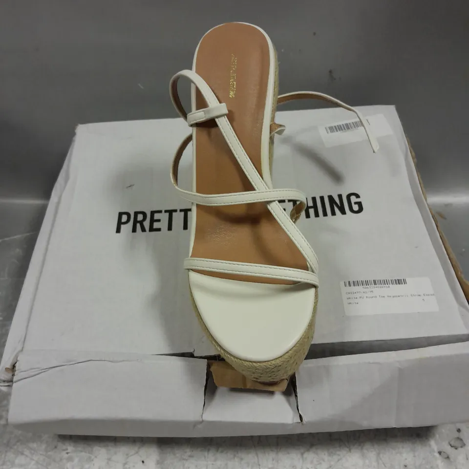 BOXED PAIR OF PRETTYLITTLETHING PU ROUND TOE ASYMMETRIC STRAP WEDGE SHOWS IN WHITE MIX SIZE 5