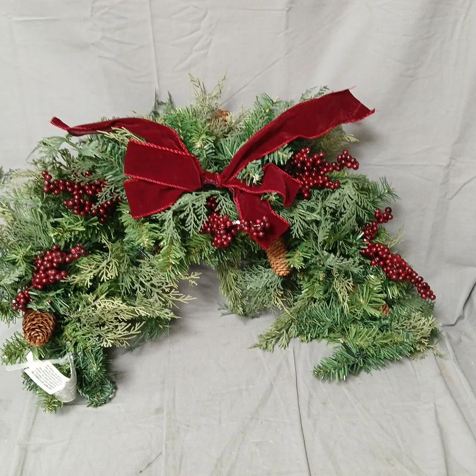 Pre-lit evergreen swag with red bow – green, with berries and pine cones