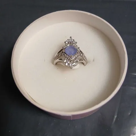 BOMB PARTY RING WITH LAVENDER CENTRAL GEMSTONE AND HALO OF CLEAR STONES – SILVER-TONE SETTING