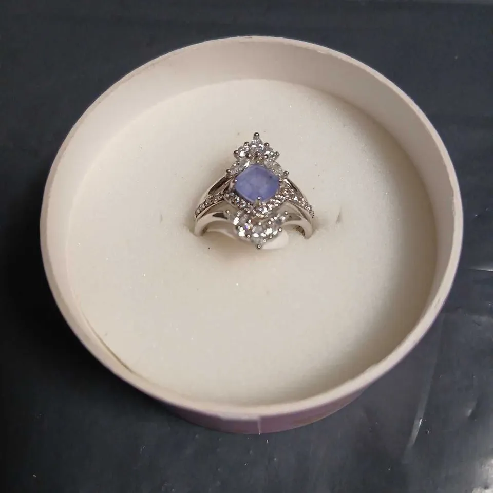 BOMB PARTY RING WITH LAVENDER CENTRAL GEMSTONE AND HALO OF CLEAR STONES – SILVER-TONE SETTING