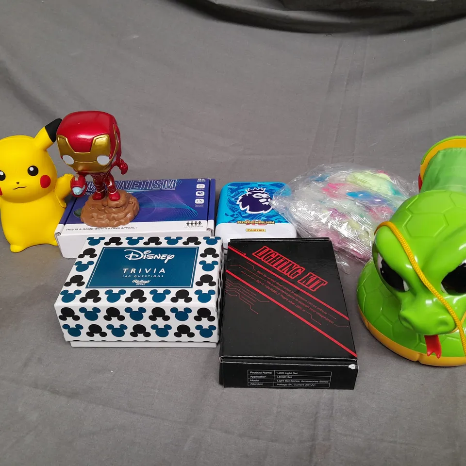 MEDIUM BOX OF ASSORTED TOYS AND GAMES TO INCLUDE STRESS BALL, TRIVIA GAME AND CARD TRAINING GAMES
