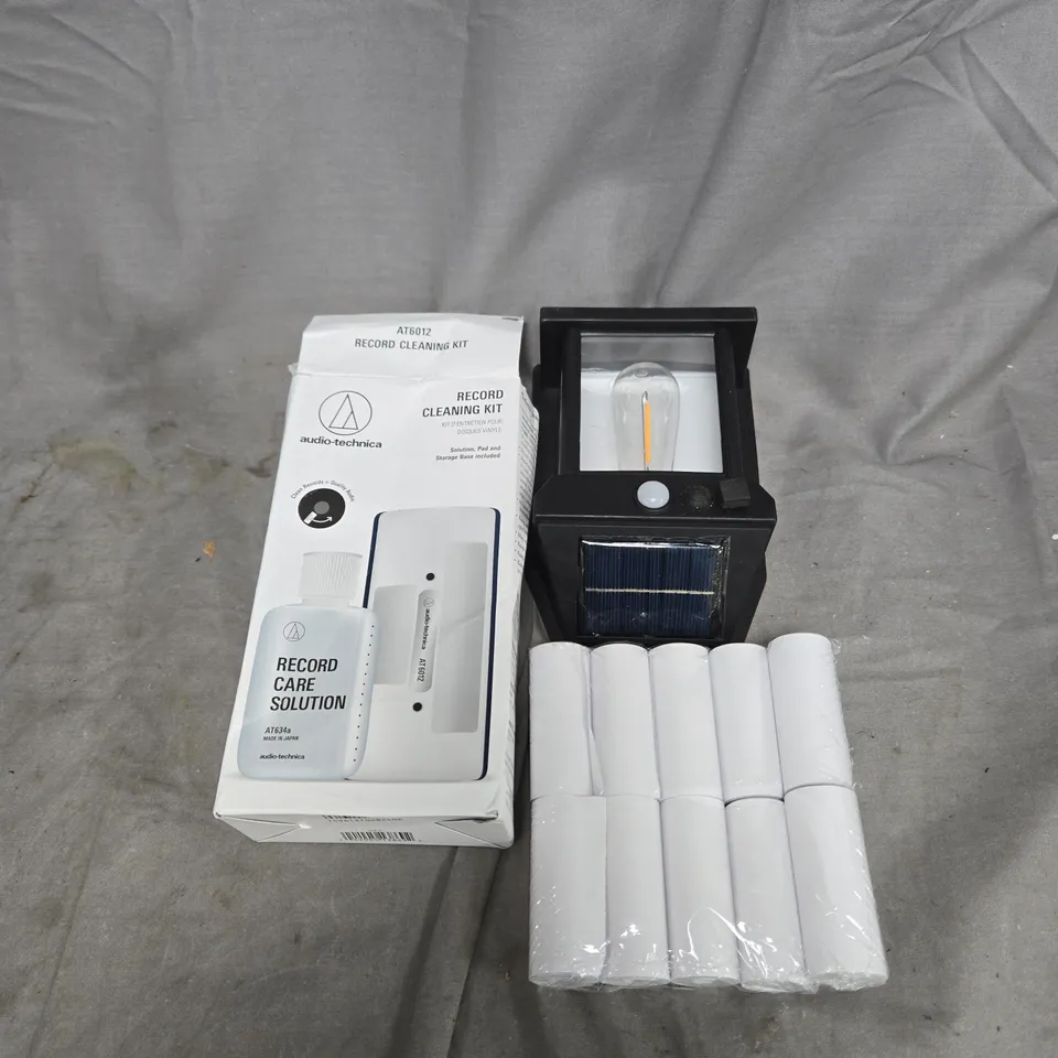 APPROXIMATELY 10 ASSORTED HOUSEHOLD ITEMS TO INCLUDE RECORD CLEANING KIT, LIGHTS, CASH REGISTER ROLLS ETC