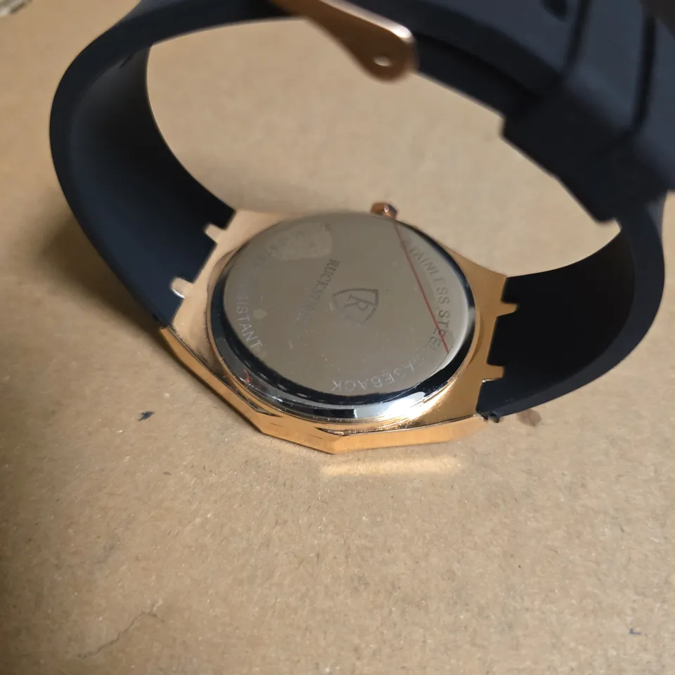 RUCKSTUHL BLACK RUBBER STRAP WRISTWATCH WITH ROSE GOLD COLOUR FRAME AND BLACK/SILVER COLOUR FACE