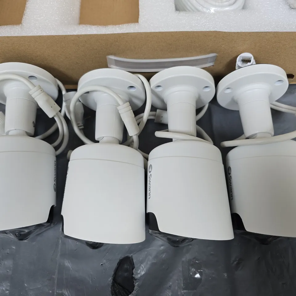 SWANN FOUR WHITE CCTV SECURITY CAMERAS WITH MOUNTING BASES AND CABLES