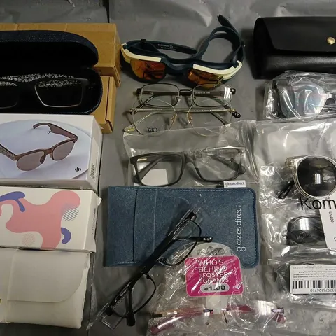 LOT OF APPROXIMATLEY 25 ASSORTED PAIRS OF GLASSES TO INCLUDE KOMONEE, GLASSES DIRECT AND SEALED WIRELESS HEADSET GLASSES