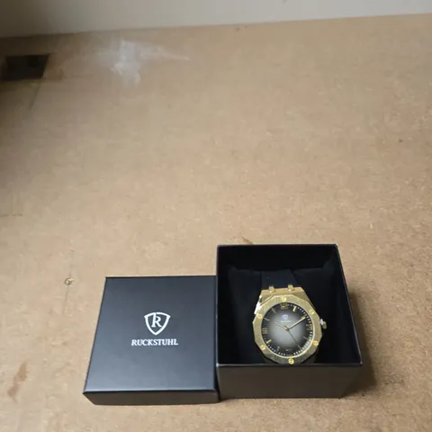 RUCKSTUHL GOLD-TONE WRISTWATCH WITH BLUE RUBBER STRAP – BOXED
