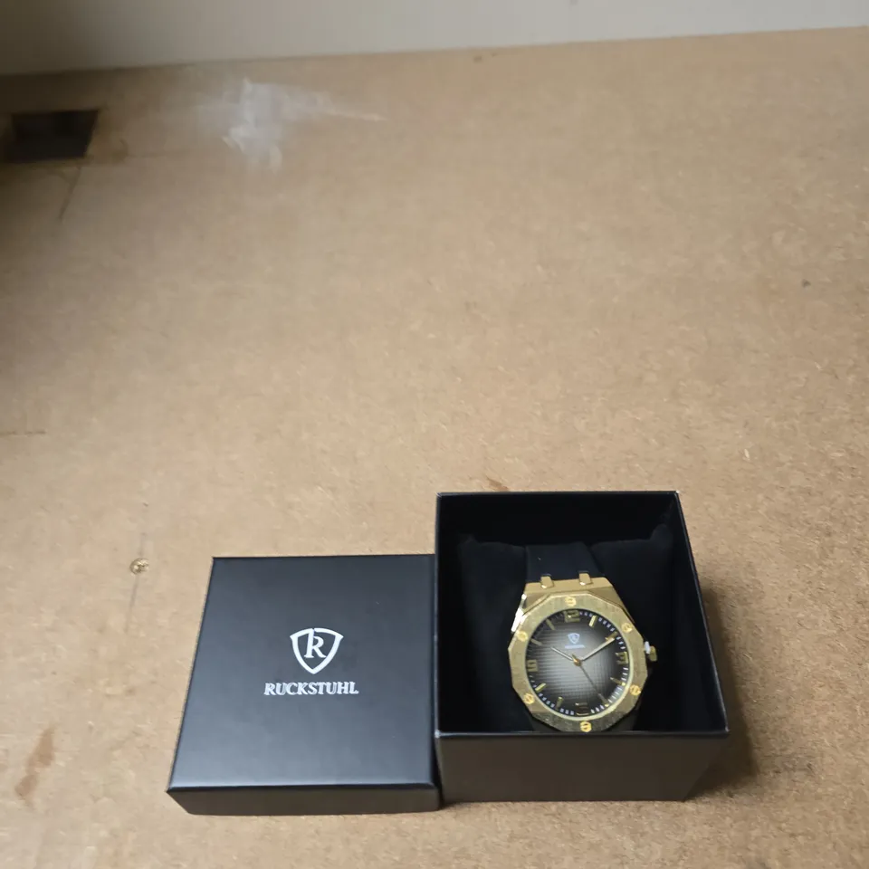 RUCKSTUHL GOLD-TONE WRISTWATCH WITH BLUE RUBBER STRAP – BOXED