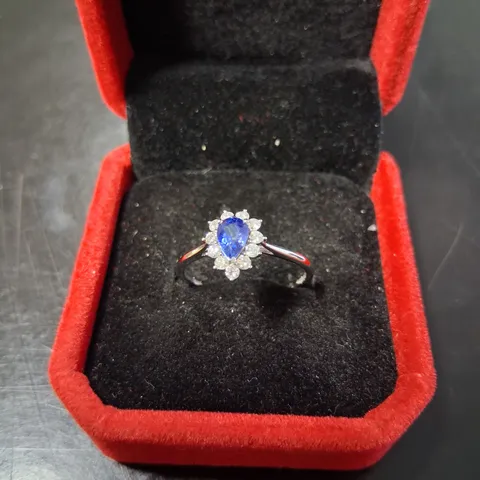 18CT WHITE GOLD RING SET WITH PEAR SHAPE SAPPHIRE WITH NATURAL DIAMONDS HALO