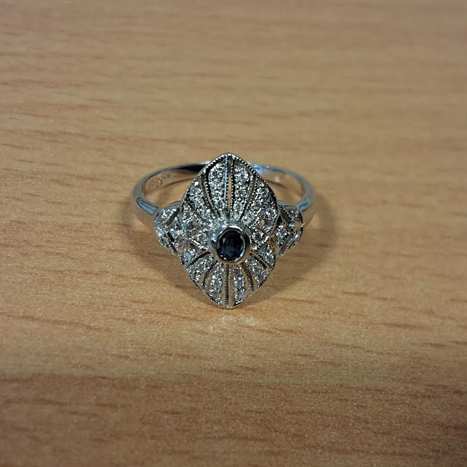 18CT WHITE GOLD DRESS RING SET WITH AN OVAL CUT SAPPHIRE AND NATURAL DIAMONDS