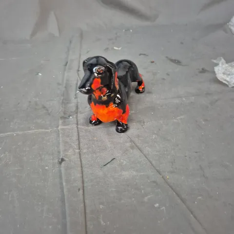 CERAMIC DOG FIGURINE, GLAZED BLACK WITH ORANGE BELLY