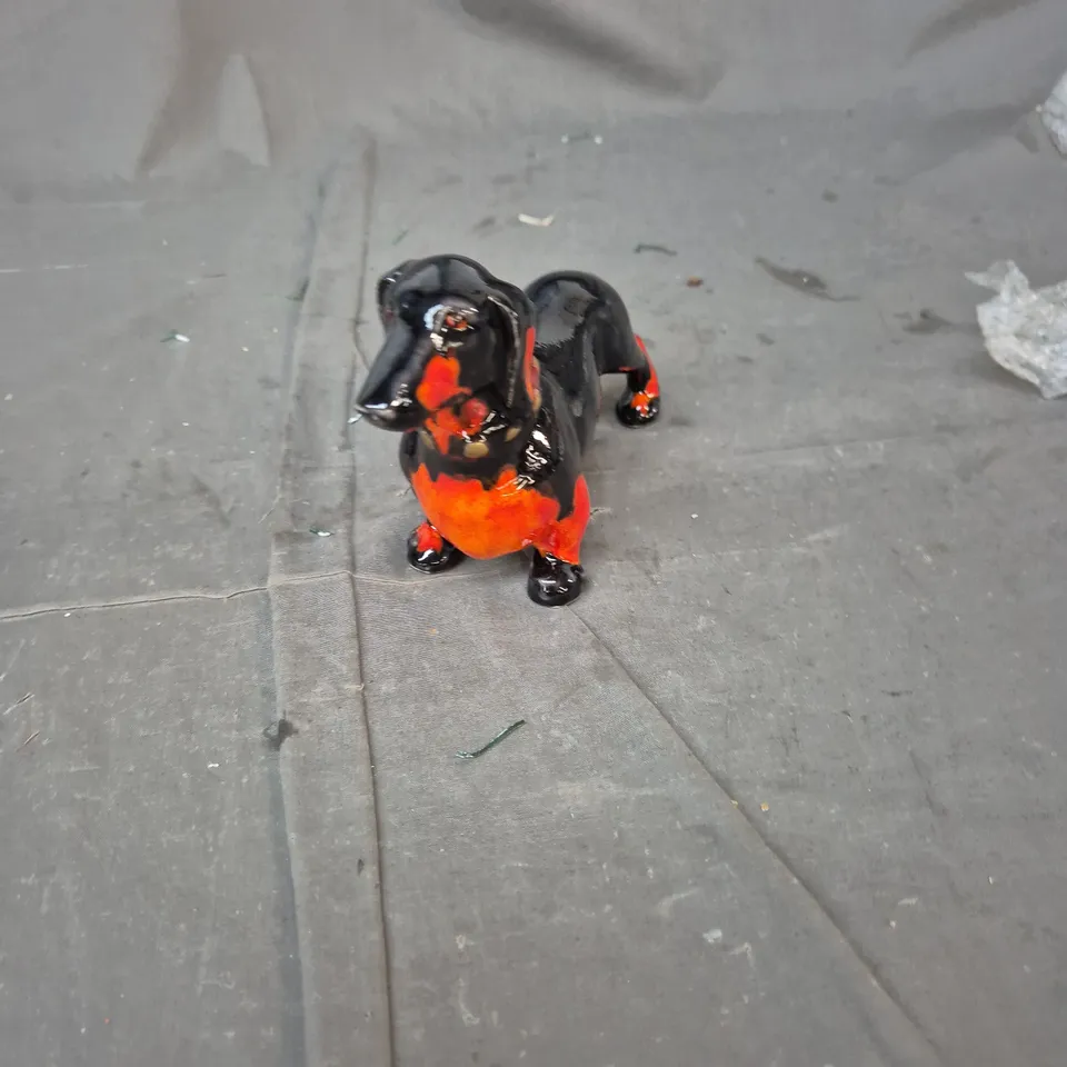 CERAMIC DOG FIGURINE, GLAZED BLACK WITH ORANGE BELLY