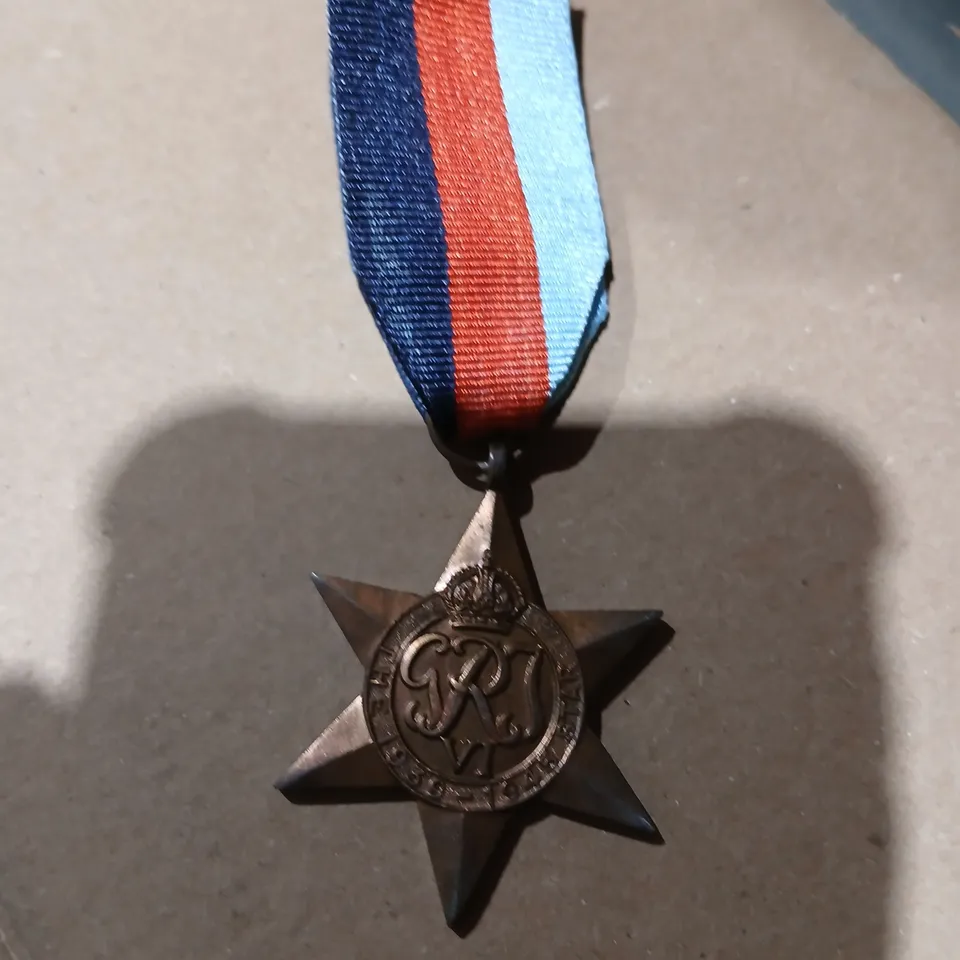 APPROXIMATELY 80 STAR-SHAPED MEDAL ON TRI-COLOR RIBBON ENGRAVED THE 1939-1945 STAR