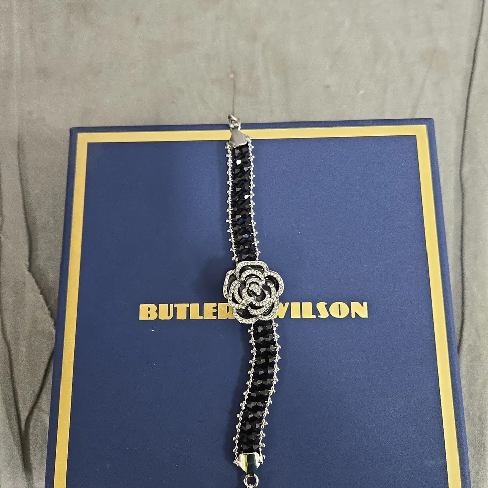 BUTLER & WILSON CRYSTAL BRACELET WITH BLACK STONES AND RHINESTONE ROSE CENTREPIECE