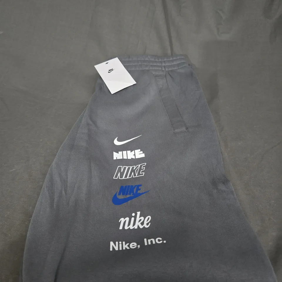 NIKE GRAPHIC TRACKSUIT BOTTOMS SIZE XL - KIDS