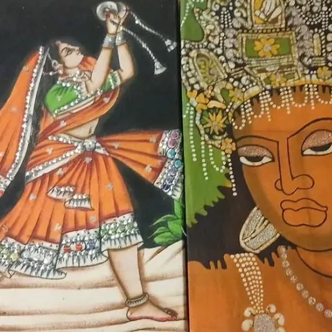 TWO  HANDMADE RAJASTHANI FABRIC STYLE WALL HANGINGS ONE DEPICTING A TRADITIONAL DANCER AND ONE DEPICTING A KERALA LADY