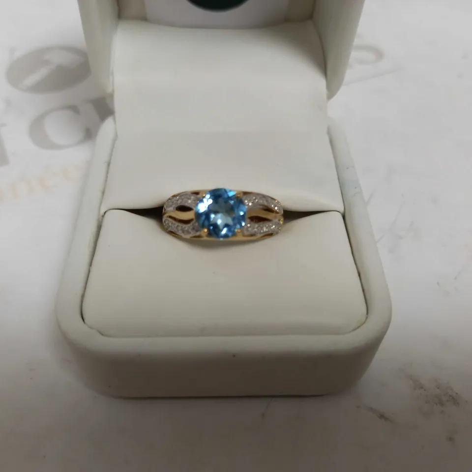 DESIGNER 9CT YELLOW GOLD RING SET WITH A BLUE TOPAZ AND DIAMONDS WEIGHING +-2.10CT