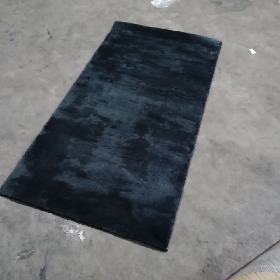 STILLAGE OF APPROXIMATELY 40 DESIGNER RUGS